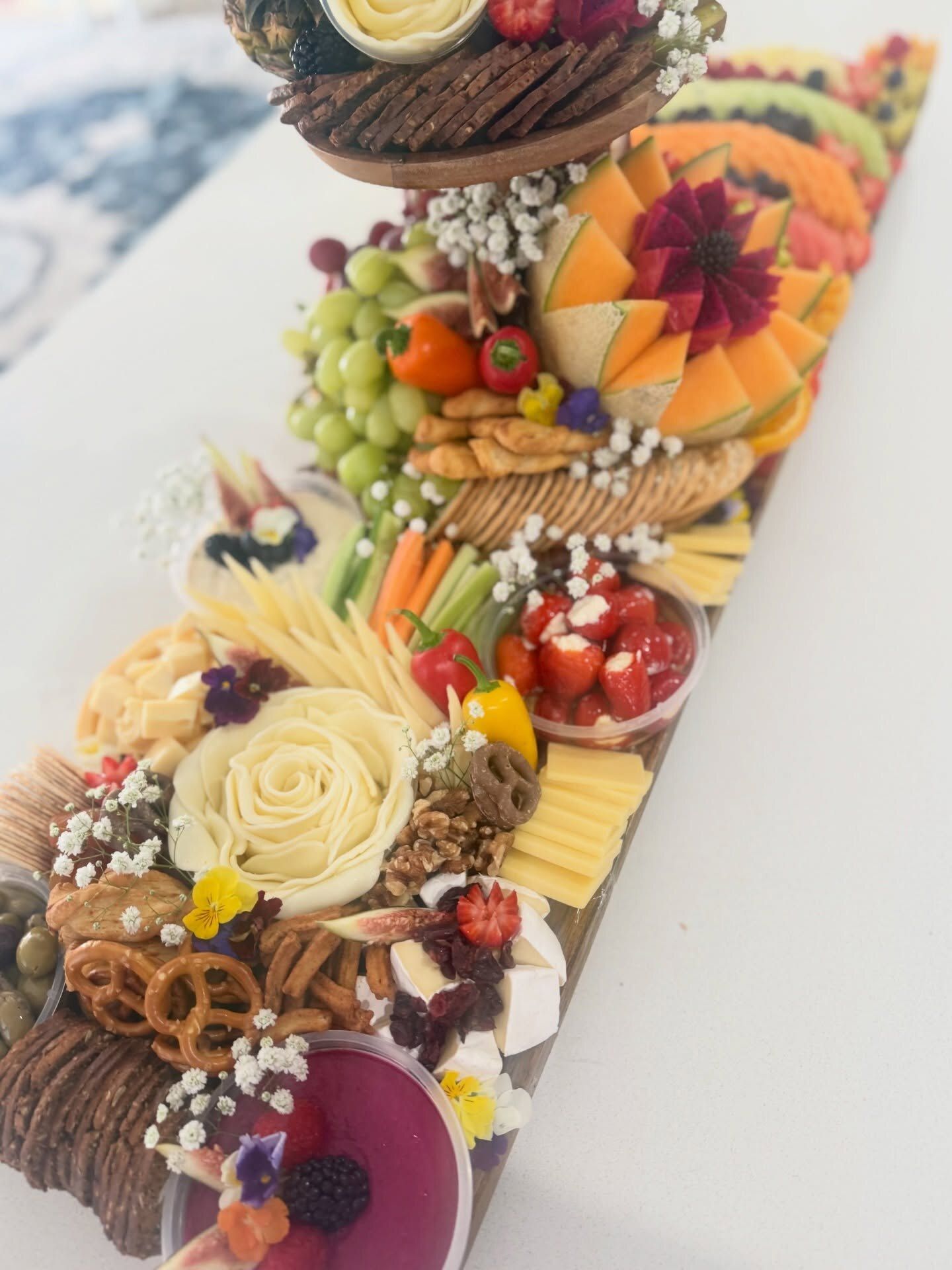 A Half and Half fruit and cheese board with a carved tier
