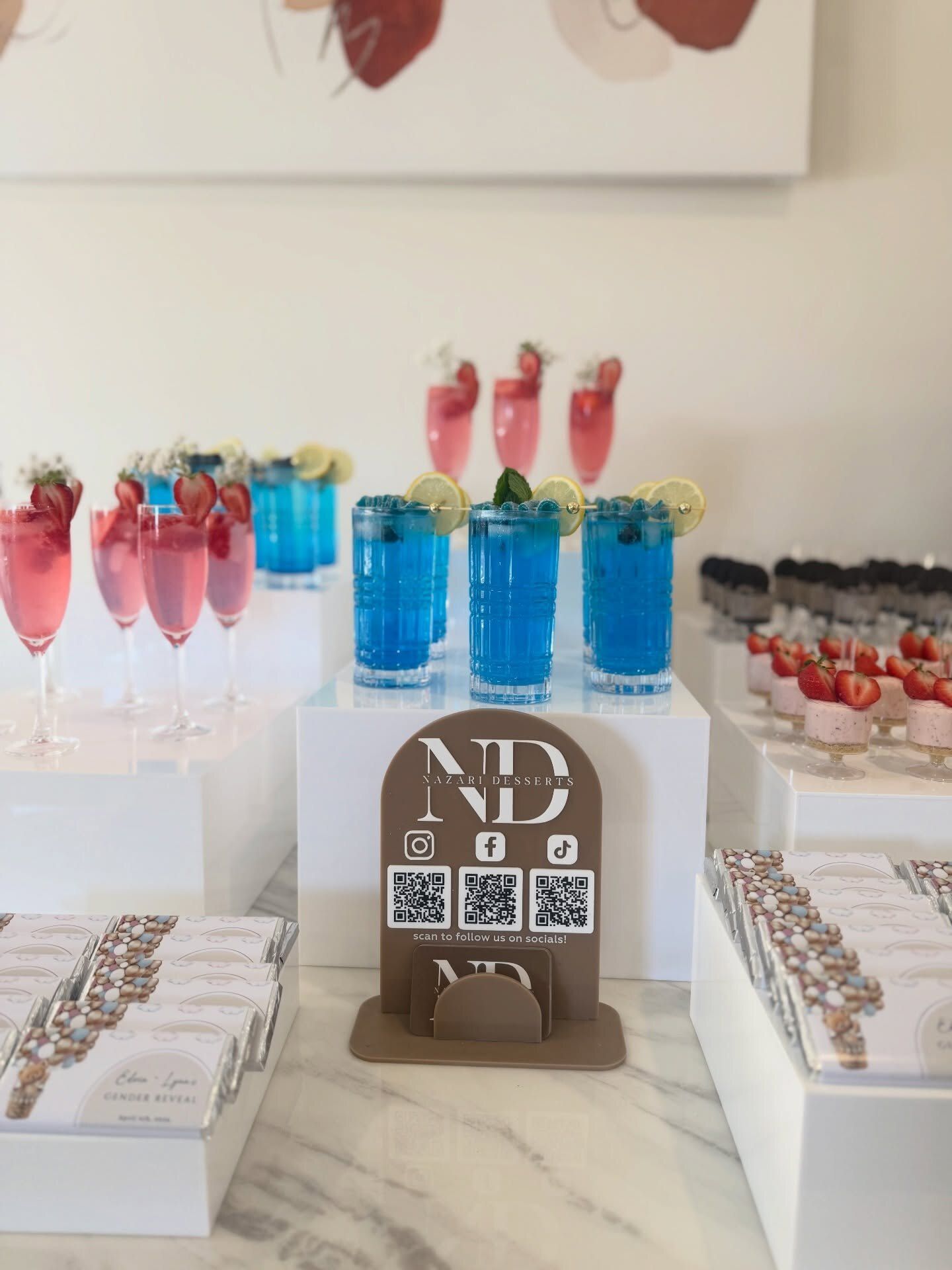 Pink lemonade and blue lagoon mocktails with dessert cups