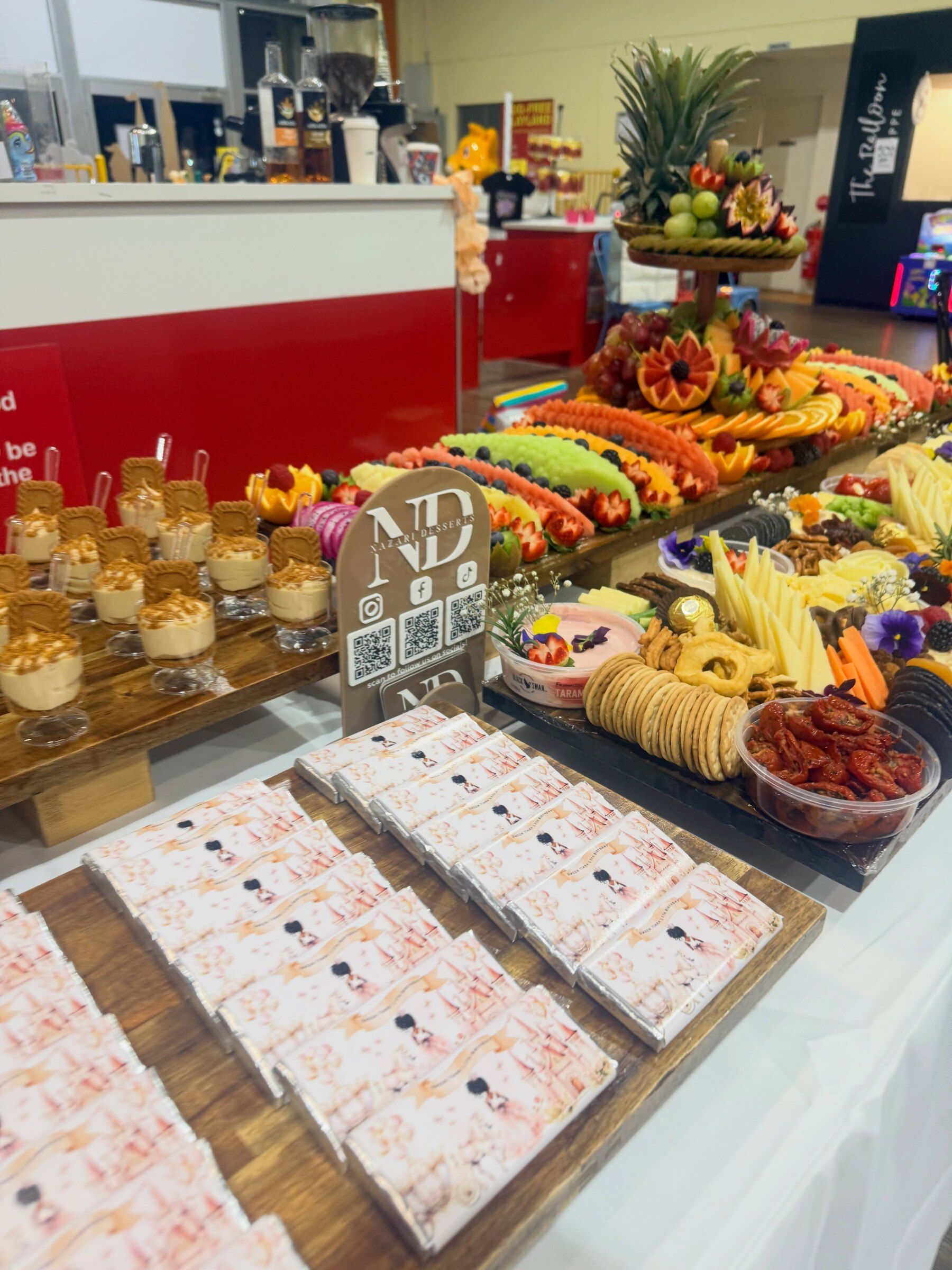 A grazing table with dessert cups and personalised chocolate bars for a birthday